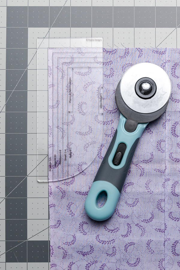 Using the Pillowcase Dress Armhole Template on a Cutting Board with Rotary Cutter